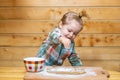 Baby boy in the kitchen helping with cooking, playing with flour. Royalty Free Stock Photo