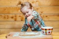 Baby boy in the kitchen helping with cooking, playing with flour. Royalty Free Stock Photo