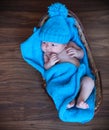 Baby boy laying on blue blanket in the basket Royalty Free Stock Photo