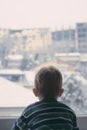 Baby boy looking at the snow Royalty Free Stock Photo