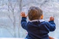 Baby boy looking through a window Royalty Free Stock Photo