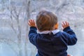 Baby boy looking through a window Royalty Free Stock Photo