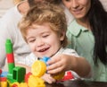 Baby boy looks at train made out of construction blocks. Royalty Free Stock Photo