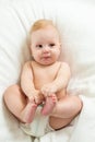 Baby boy lying on white sheet Royalty Free Stock Photo