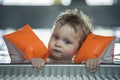 Baby boy makes face in a swiming pool Royalty Free Stock Photo