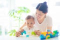 Baby boy and mother playing with toy Royalty Free Stock Photo