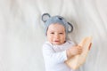Baby boy in mouse hat lying on blanket with cheese Royalty Free Stock Photo