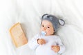 Baby boy in mouse hat lying on blanket with cheese Royalty Free Stock Photo