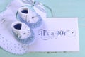 Baby boy nursery blue and white wool booties and card Royalty Free Stock Photo