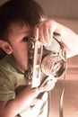 Baby boy and old camera in hand Royalty Free Stock Photo