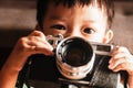 Baby boy and old camera in hand Royalty Free Stock Photo