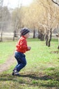 Baby boy in orange jaket and blue jeans Royalty Free Stock Photo