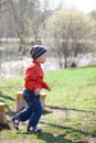 Baby boy in orange jaket and blue jeans Royalty Free Stock Photo