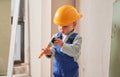 Baby boy painting wall in apartment under renovation. Royalty Free Stock Photo