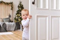 Children peeking out of the open room door