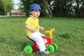 Baby boy on plastic run bike outdoors