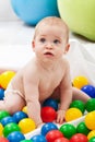 Baby boy playing with colorful plastic balls Royalty Free Stock Photo