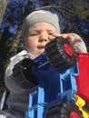 Baby boy playing with dump truck in the park