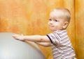 Baby boy playing with fit ball Royalty Free Stock Photo