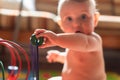 Baby boy playing with his colored toys