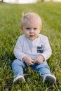 Cute and Adorable Young Toddler Baby Boy Playing in the Backyard Green Grass and Smiling at the Camera Royalty Free Stock Photo