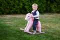 Baby boy playing with horse on playground in park Royalty Free Stock Photo