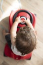 Baby boy playing with push car. Top view, indoor Royalty Free Stock Photo