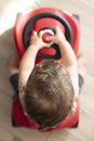 Baby boy playing with push car. Top view, indoor Royalty Free Stock Photo