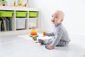 Baby boy playing in pyramid and wooden toys. early children development