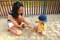 Baby boy playing with sand in sandbox Royalty Free Stock Photo