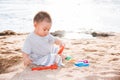 Baby boy playing sand on sea beach Royalty Free Stock Photo