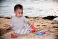 Baby boy playing sand on sea beach Royalty Free Stock Photo