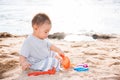 Baby boy playing sand on sea beach Royalty Free Stock Photo