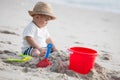 Baby boy playing with sand on tropical beach. Royalty Free Stock Photo