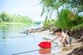 Baby boy playing with ship toy at sea. Child os on vacation in summer at the beach on vacations