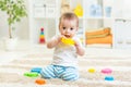 Baby boy playing with toys indoor Royalty Free Stock Photo