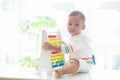 Baby boy playing with wooden abacus Royalty Free Stock Photo