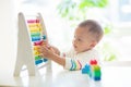 Baby boy playing with wooden abacus Royalty Free Stock Photo