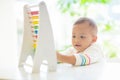 Baby boy playing with wooden abacus Royalty Free Stock Photo