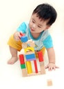 Baby boy playing wooden blocks