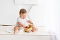 Baby boy playing wooden toy typewriter at home, the concept of play and development of children Royalty Free Stock Photo