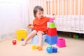 Baby boy plays toys sitting on potty