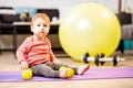 Baby boy portrait with dumbbells and fitness ball at home Royalty Free Stock Photo