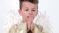 Baby boy praying he in the form of an angel with white wings in the studio on white.