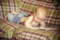 Baby boy read book on sofa Royalty Free Stock Photo