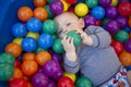 Baby boy with reusable nappy diaper in ball pond Royalty Free Stock Photo
