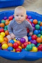 Baby boy with reusable nappy diaper in ball pond Royalty Free Stock Photo