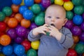 Baby boy with reusable nappy diaper in ball pond Royalty Free Stock Photo