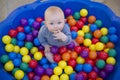 Baby boy with reusable nappy diaper in ball pond Royalty Free Stock Photo