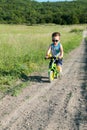 Baby boy riding on his first bike without pedals Royalty Free Stock Photo